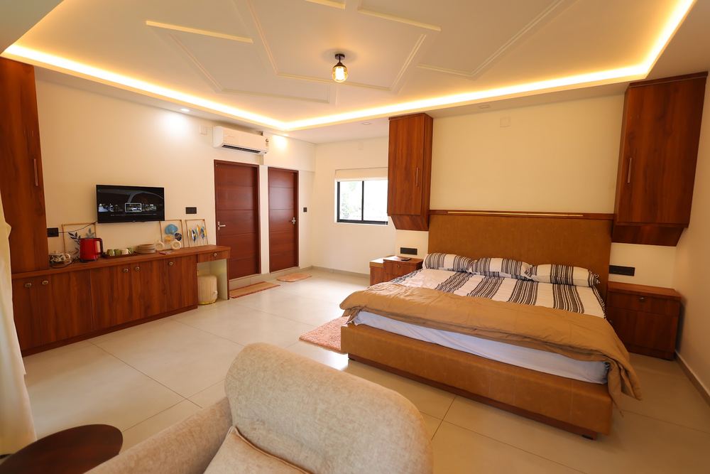 Wide view of the bed, wardrobe wall and entry doors