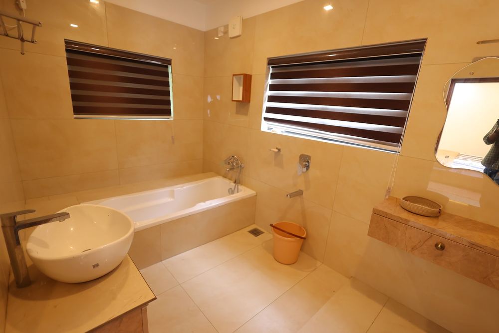 Marble bathroom with a soaking tub, vessel sink and window